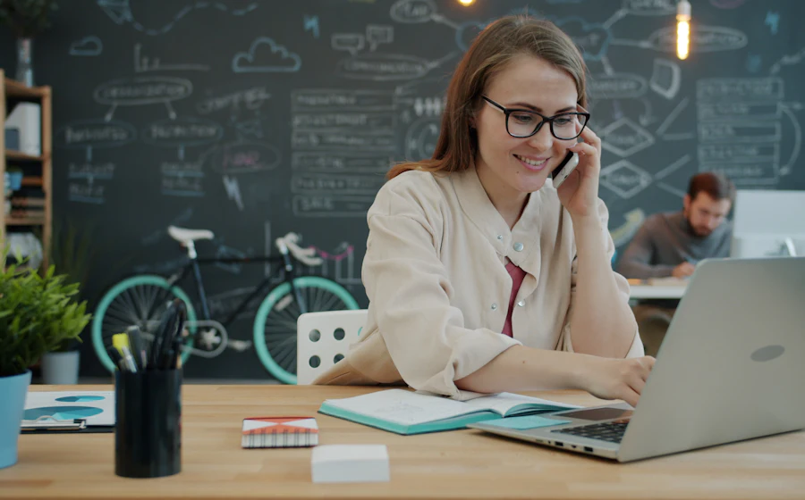 A business owner on the phone at her laptop