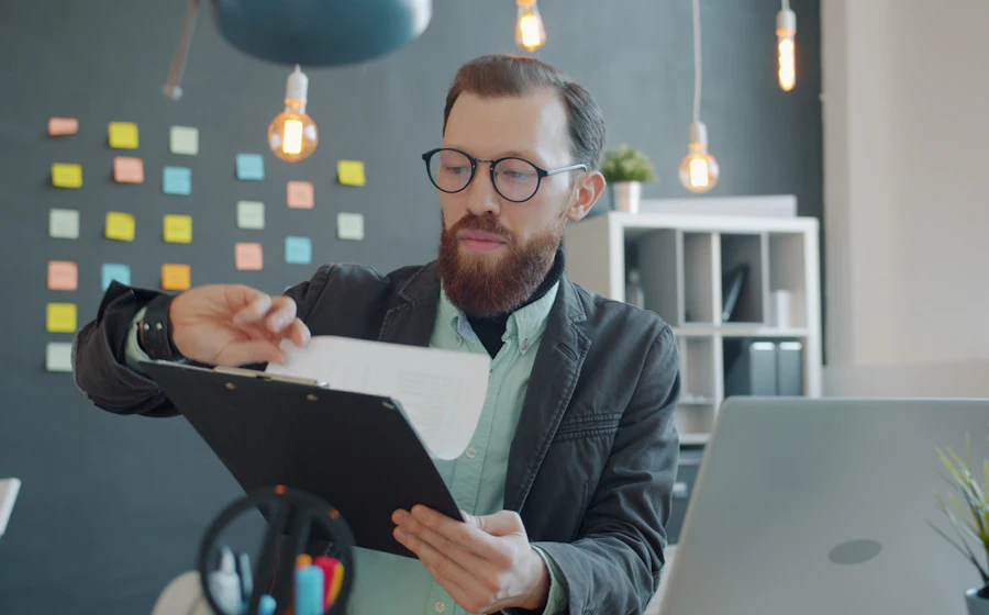 A business owner reviewing a report at his desk